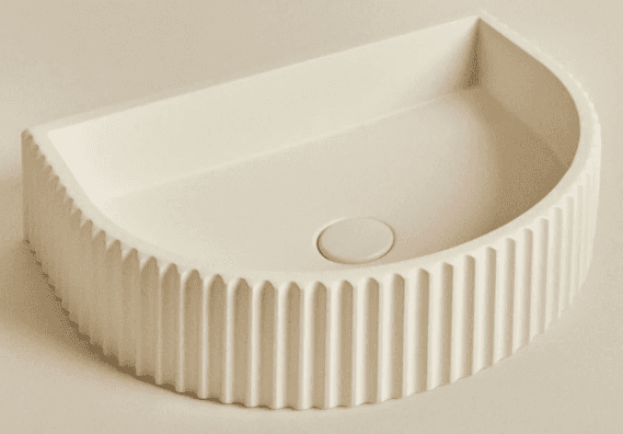 A countertop sink with a semi-circular basin and a decorative fluted exterior. The sink features a c… — 3D model