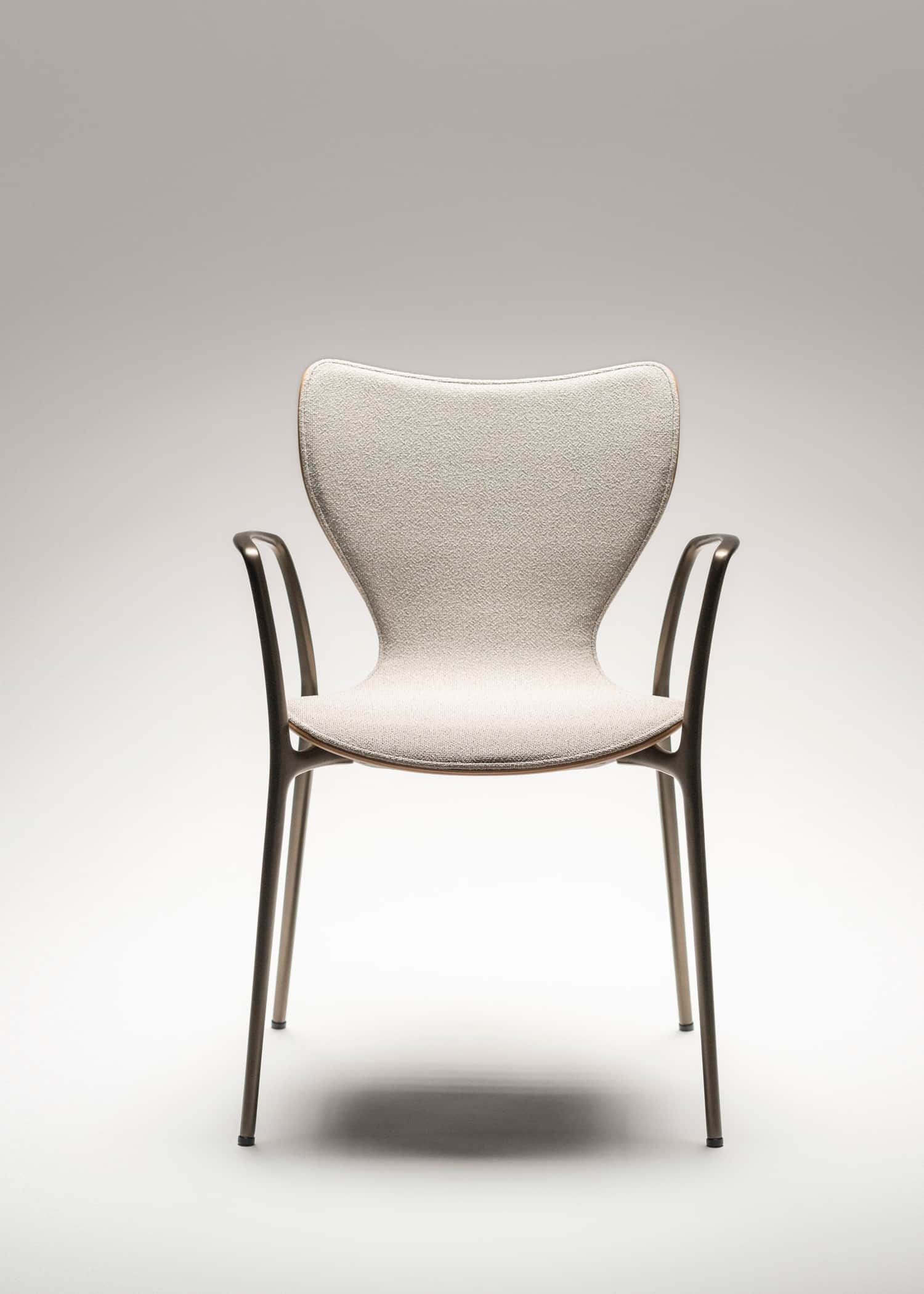 A modern armchair with a distinct, contoured backrest and a upholstered seat. The frame and legs are… — free OBJ 3D model