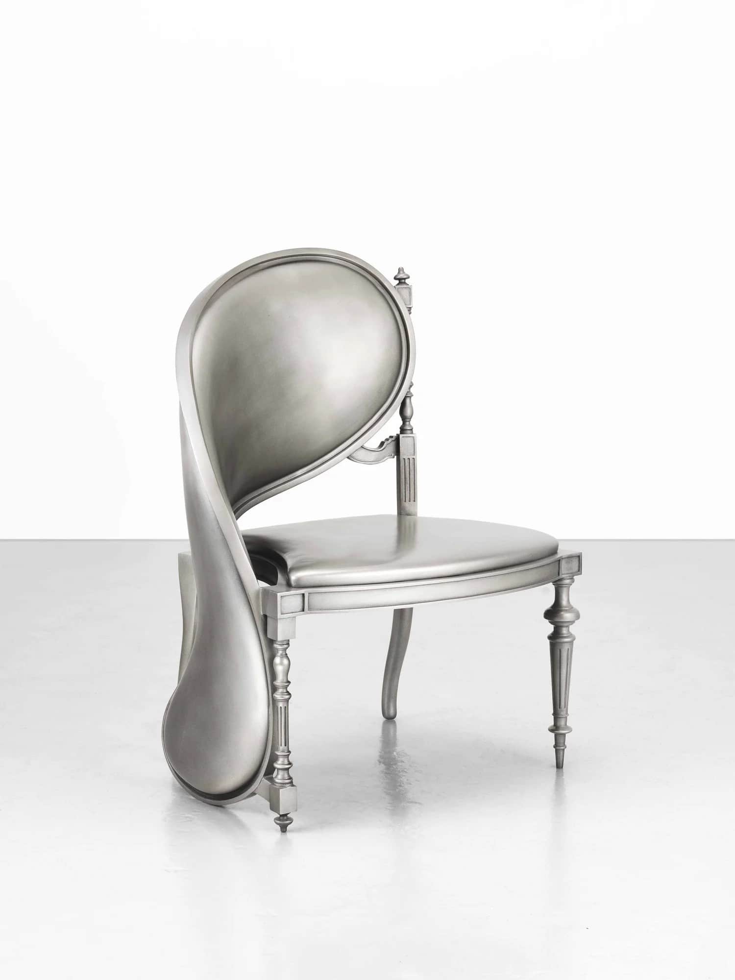 A silver-colored chair with a distinctive, flowing backrest that appears to be melting or contorting… — free FBX 3D model