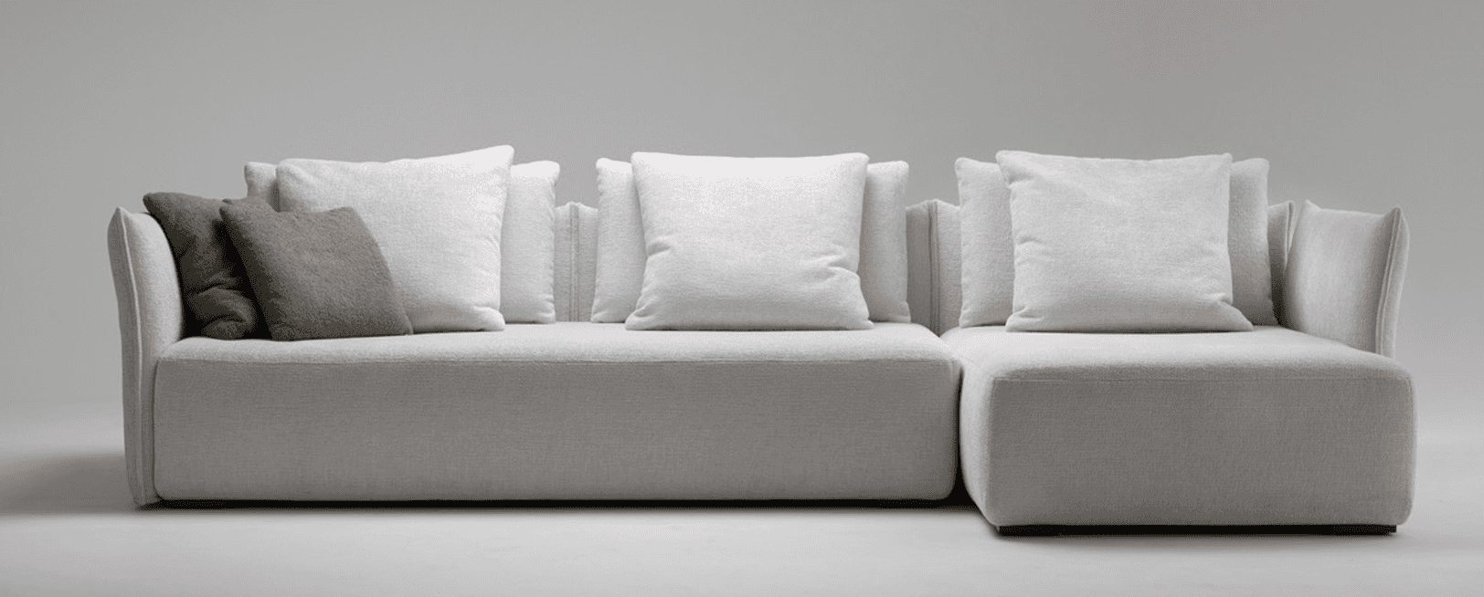 A modern, modular sectional sofa with a light grey upholstery. The sofa features deep, plush seating… — 3D model