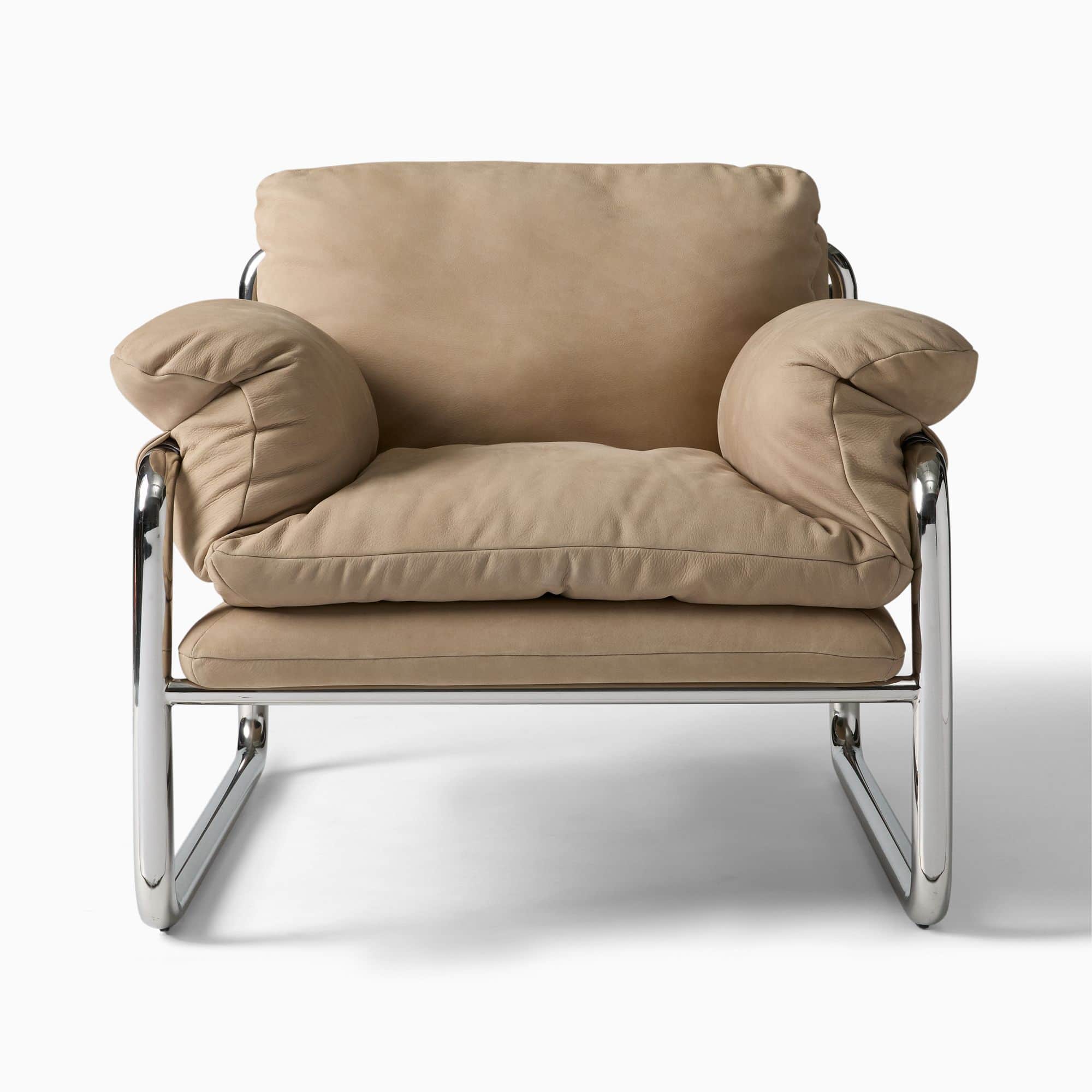 A plush armchair featuring a tubular chrome-plated steel frame and thick, upholstered cushions in a… — 3D model
