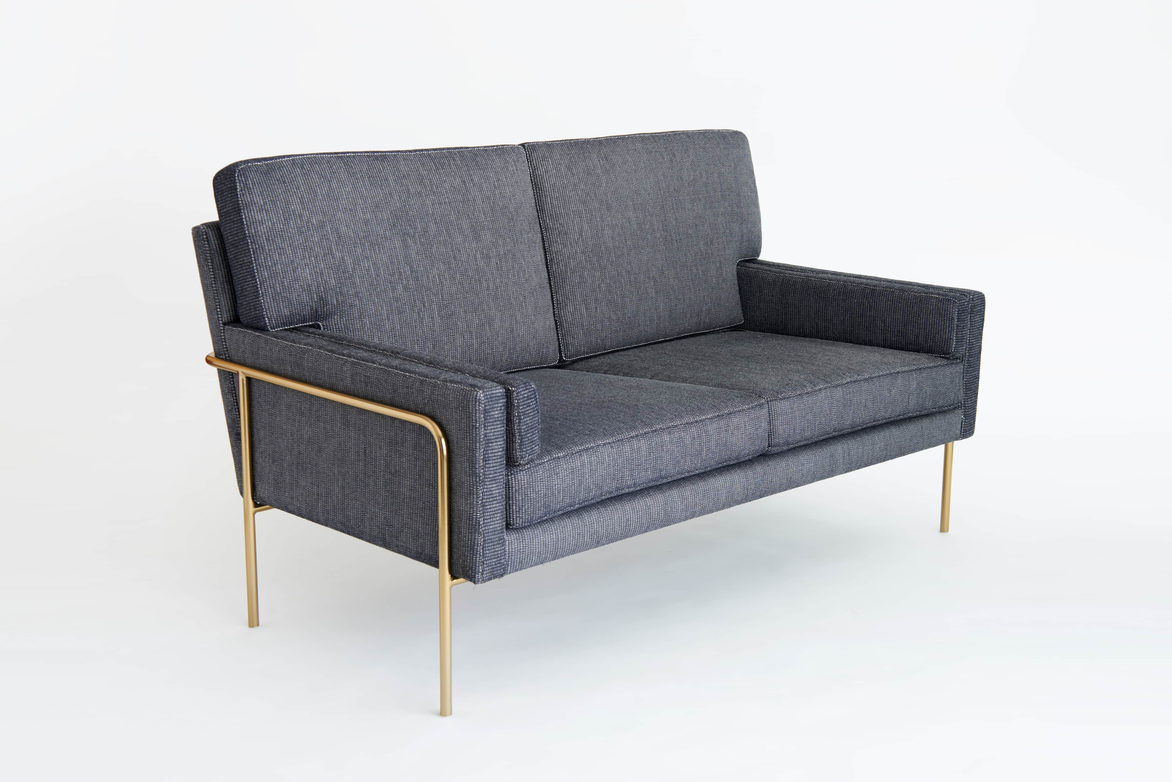 A two-seater sofa with a modern design. The sofa features a rectangular frame upholstered in dark gr… — free GLTF 3D model
