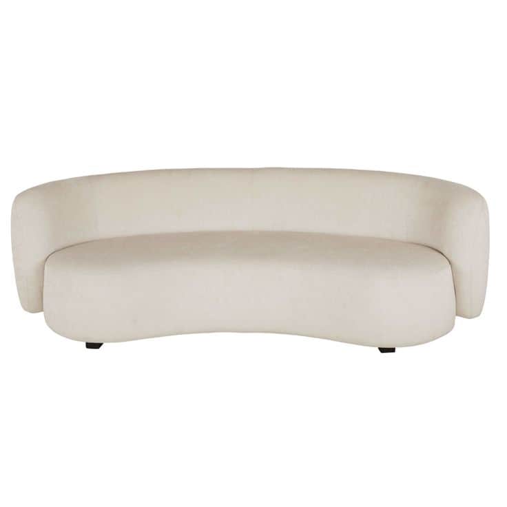 A cream-colored, curved sofa with a plush fabric upholstery. The sofa features rounded arms that sea… — free OBJ 3D model