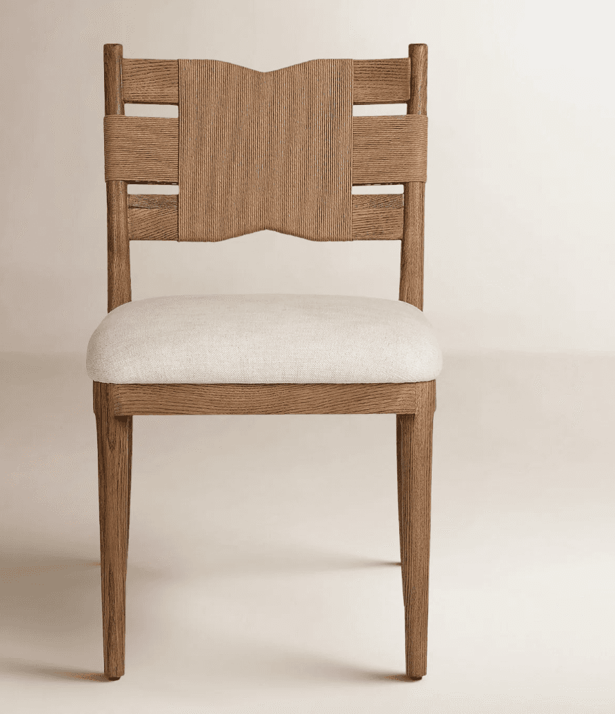 A modern dining chair featuring a light-toned solid wood frame, a distinctive backrest with vertical… — 3D model