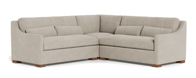A sectional sofa with a neutral-toned upholstery. It features a contemporary design with clean lines and plush cushions. The sofa is configured in an L-shape, suggesting it's designed for a corner placement. The frame is supported by low-profile wooden feet. — 3D model