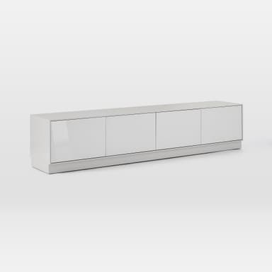 A sleek, modern media console with a low-profile design, featuring four equally sized, handle-less doors for storage. The unit is finished in a light gray or off-white hue, with the doors appearing to have a glossy or lacquered finish, contrasting with a potentially matte finish on the top surface and base. It rests on a discreet plinth base, contributing to its minimalist aesthetic. The clean lines and flush-fitting doors emphasize contemporary design. — 3D model