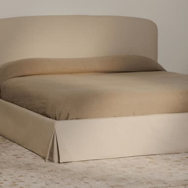 A modern platform bed with a gently curved, upholstered headboard and a rectangular, upholstered base. The bed is dressed in neutral-toned linens. Flanking the bed are two matching wooden nightstands with minimalist designs, featuring drawers and open shelving. — 3D model