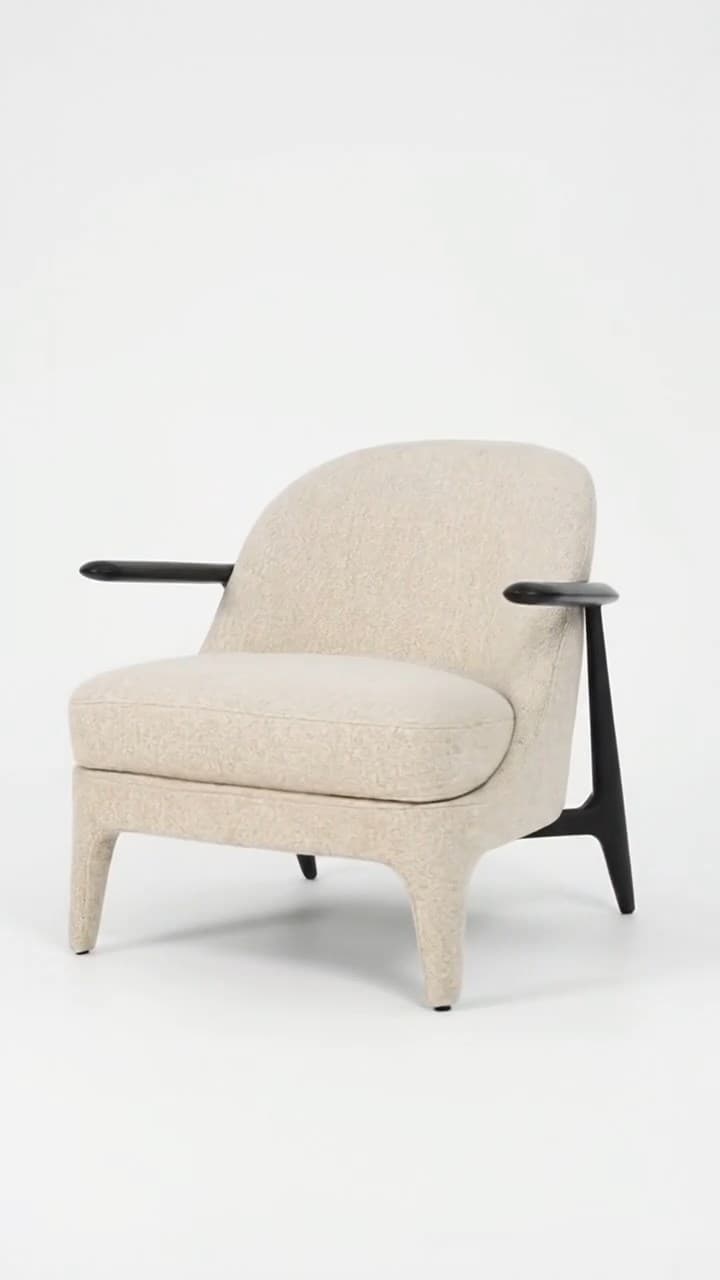 A contemporary lounge chair featuring a generously upholstered body in a light beige textured fabric, complemented by sleek, dark-stained wooden armrests and subtly tapered wooden legs. — 3D model
