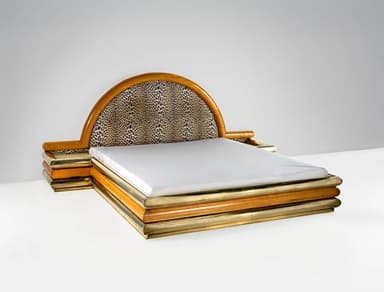A bed frame with a distinctive design, featuring layered cylindrical elements in wood and brass around the base, and a semicircular headboard upholstered in a leopard-print fabric, framed by polished wood. — 3D model