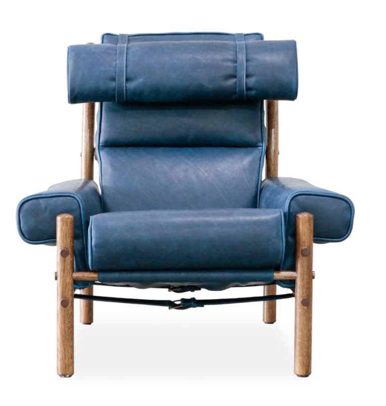 A high-backed armchair with a distinct, padded headrest secured by leather straps. The seat and back cushions are segmented, creating a tufted appearance. The frame is constructed from natural wood posts, with visible metal fasteners and leather strapping supporting the seat. — 3D model