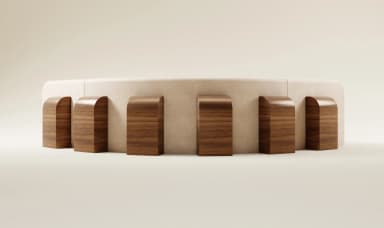 A modular, sectional sofa with a curved design and plush upholstery. It features a low profile with rounded corners and is complemented by multiple scatter cushions. The sofa appears to be constructed from a fabric material and is arranged in an L-shape. — 3D model