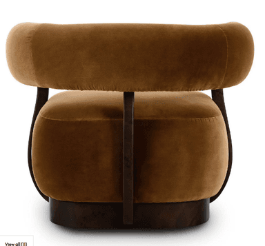 An Art Deco style barrel armchair upholstered in plush brown velvet with a dark, possibly burl wood, veneer frame. The chair features a curved back and integrated arms, all padded and upholstered. The wooden frame provides structural support, flowing from the base up to encompass the back and arms. The seat cushion is thick and round, resting on a sturdy, rounded wooden base. — 3D model
