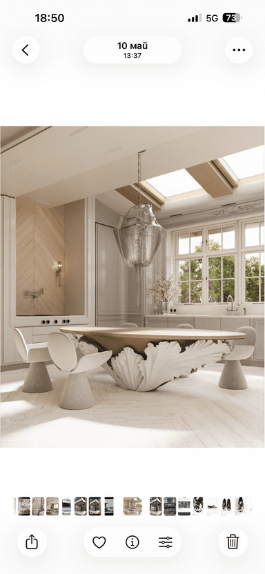 An oval-shaped coffee table featuring a light-toned wood tabletop and a distinctive, sculptural white base. The base has an organic, leaf-like or petal-like design, giving it a unique and artistic appearance. The table stands on a clean white background, highlighting its contemporary and elegant form. — 3D model