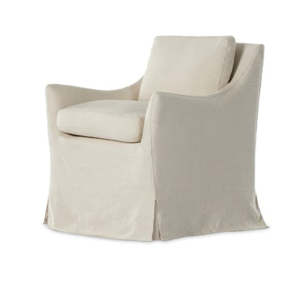 A slipcovered armchair with a relaxed, casual aesthetic. It features plush seat and back cushions, and a skirted base that extends to the floor. The armrests have a gentle slope. — 3D model