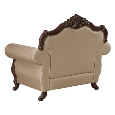 An ornate single-seater armchair featuring a dark, richly carved wooden frame with gilded accents, and plush, light beige upholstered seating. The chair's design includes a prominent crest rail with intricate rococo-style carvings, scrolled armrests, and cabriole-style legs, all detailed with gold. The upholstery is secured by continuous brass nailhead trim along the edges. — 3D model