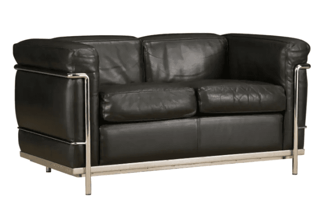 A modernist two-seater sofa featuring a distinctive exposed tubular chrome-plated steel frame encasing deep, loose black leather cushions for the seat, back, and arms. The design is characterized by its geometric lines and industrial aesthetic, typical of the International Style or Bauhaus movement. — 3D model