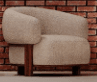 A modern armchair featuring a curved, enveloping tub-style silhouette. It is upholstered in a textured, light cream or off-white boucle fabric. The upholstered body sits atop a distinctive exposed dark wood base, which also forms the short, sturdy legs. The design combines soft, rounded forms with clean lines from the wooden elements, creating a sculptural and inviting piece. — 3D model