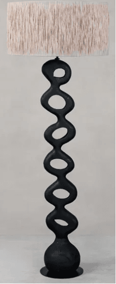 A contemporary floor lamp featuring a distinctive sculptural base composed of interconnected organic forms, finished in a matte black, topped with a plain cylindrical beige fabric drum shade. — 3D model