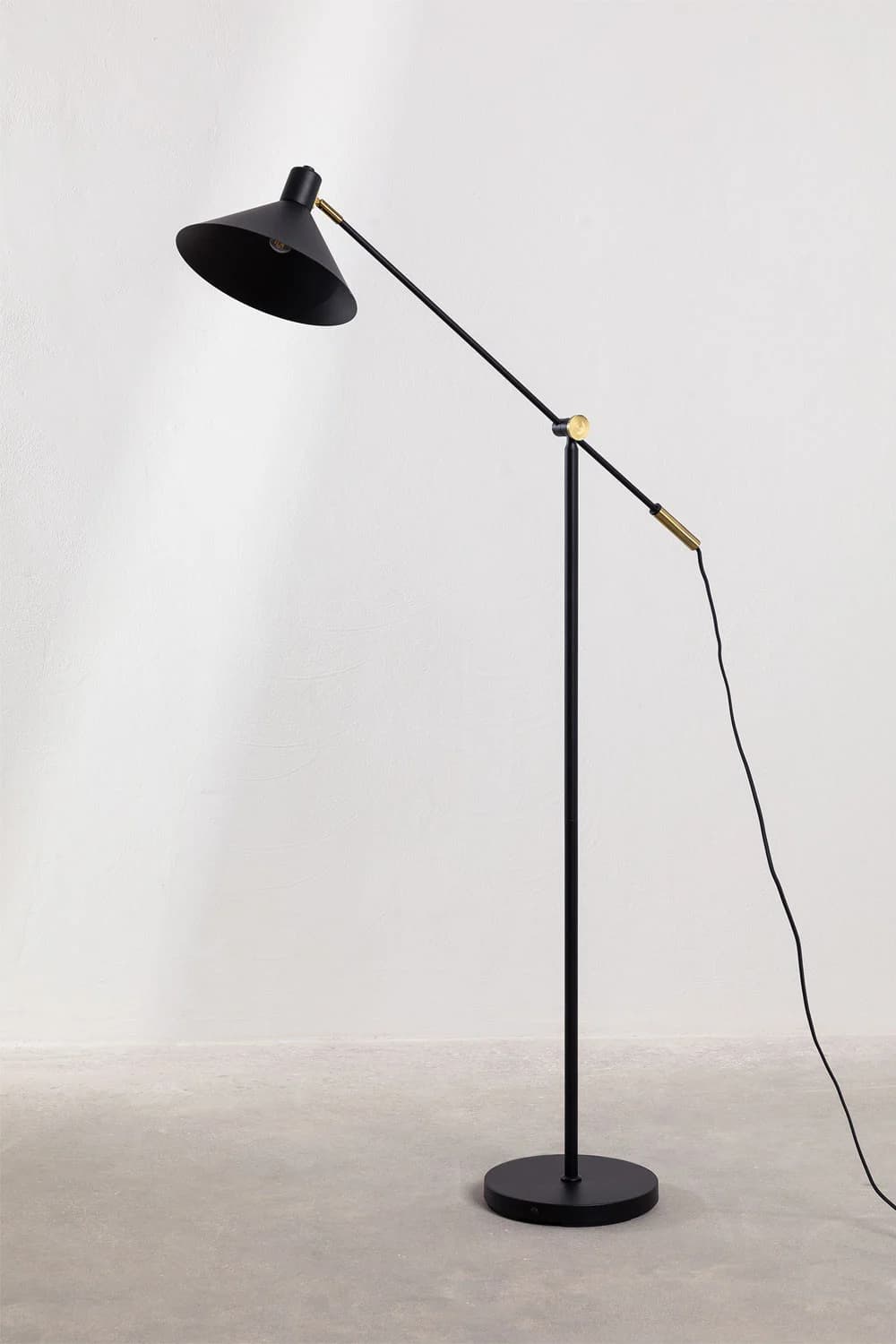 A sleek, modern floor lamp featuring a matte black finish and brass accents. It has an articulated arm for adjustable lighting direction and a conical shade. — 3D model
