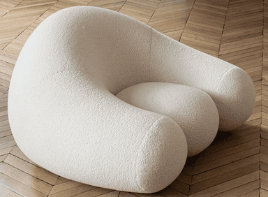 A light grey, upholstered, organically shaped piece of furniture, resembling a large smooth pebble or rock. Its surface appears to be a soft, textured fabric. — 3D model