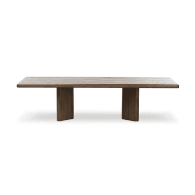 A rectangular dining table with a thick, solid wood top featuring a light, weathered finish and pronounced wood grain patterns. The base consists of two substantial, vertical wooden supports with rounded edges, finished in a darker, rich brown tone. The overall design evokes a rustic or natural aesthetic. — 3D model