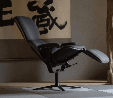 A sophisticated, high-tech reclining chair featuring multiple articulated segments for customized ergonomic support. The chair is upholstered in a dark gray fabric with lighter gray trim, set upon a robust, light gray metal frame that showcases advanced adjustability mechanisms for the backrest, seat, armrests, and integrated footrest. Its design emphasizes comfort and modern aesthetics. — 3D model