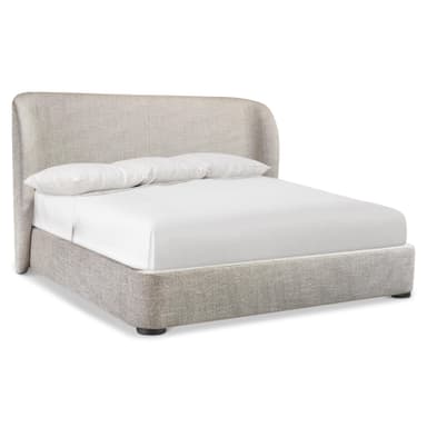 A modern platform bed featuring a fully upholstered frame and headboard in a light beige, textured fabric. The headboard has gently rounded top corners, presenting a soft, contemporary silhouette. The low-profile design is supported by small, dark, cylindrical feet, creating a clean and minimalist aesthetic. — 3D model