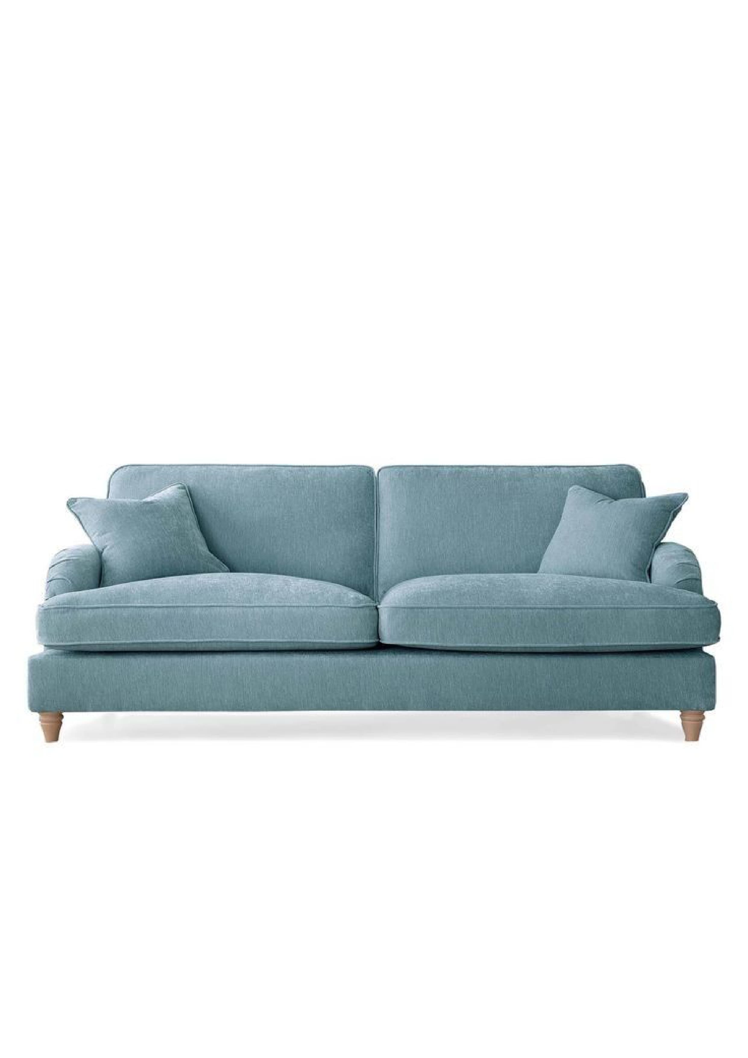 A light blue, two-seater sofa with fabric upholstery, featuring rolled armrests, two plump seat cushions, two back cushions, and two matching throw pillows. It stands on short, light-toned wooden legs, presenting a comfortable and classic contemporary design. — 3D model