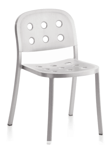 A modern chair with a brushed aluminum finish. It features a curved backrest and seat, both perforated with a pattern of six circular holes each. The chair has four slender, straight legs that taper slightly towards the bottom. — 3D model