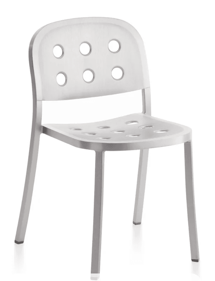 A modern chair with a brushed aluminum finish. It features a curved backrest and seat, both perforated with a pattern of six circular holes each. The chair has four slender, straight legs that taper slightly towards the bottom. — 3D model