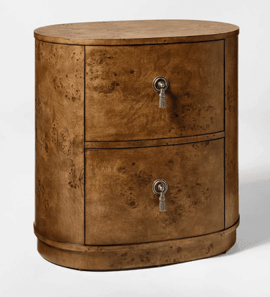 A two-drawer oval nightstand crafted from burl wood veneer, featuring a rich, mottled grain. Each drawer is equipped with a decorative antique silver-toned tassel-shaped pull. The piece has a sleek, rounded silhouette with a flat top and a slightly recessed base. — 3D model