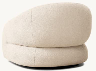 A contemporary armchair with a distinctive rounded silhouette. The chair features a plush, textured upholstery and a low-profile base. Its design emphasizes comfort and organic forms, suitable for modern living spaces. — 3D model