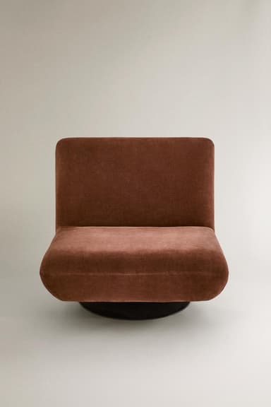 A single-seat armchair with a low profile and a swivel base. The chair features a upholstered seat and backrest with a slightly reclined angle. The base appears to be circular and black, allowing for rotation of the seating unit. — 3D model
