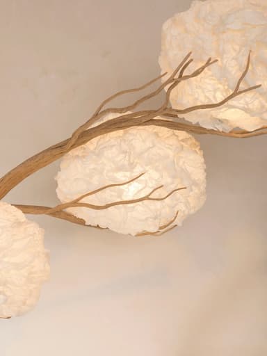 An artistic floor lamp featuring a natural wood block base, a gracefully curving branch-like stem, and three spherical, crinkled white paper or fabric shades designed to resemble blossoms or clouds. — 3D model