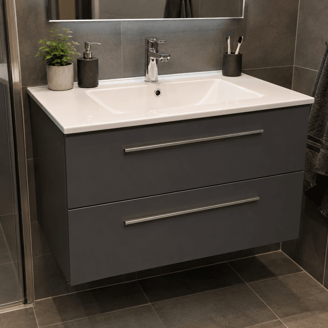 A modern wall-mounted bathroom vanity featuring a dark grey cabinet, a white integrated sink, and a chrome faucet. The cabinet has two large drawers with slim, horizontal chrome bar pulls. — 3D model