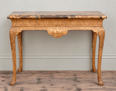 An ornate console table featuring a variegated marble top and a heavily carved giltwood frame. The table stands on four cabriole legs with carved detailing, and its apron is elaborately scalloped and embellished with relief carvings. The gilding shows signs of age and wear, contributing to its antique appearance. — 3D model