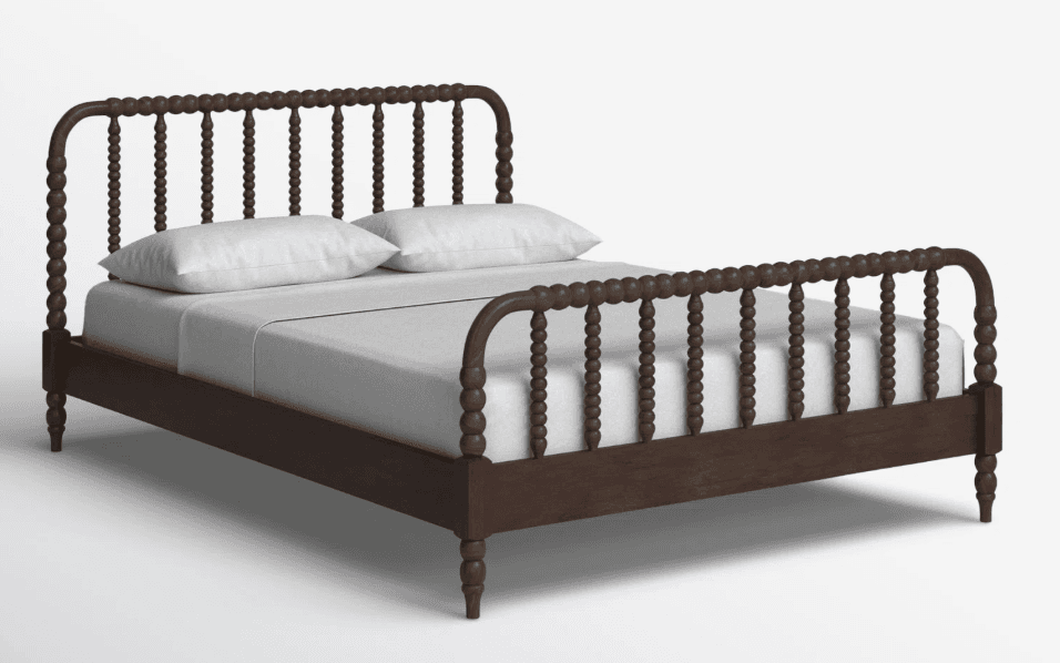 A dark brown wooden bed frame with a headboard and footboard featuring turned spindles and decorative bobbles. The bed is shown with white bedding and two pillows. — 3D model