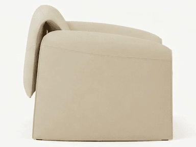 A cream-colored, contemporary lounge chair characterized by its smooth, sculptural form and thick, upholstered construction. The chair features integrated armrests and legs that curve seamlessly from the main body, creating a monolithic aesthetic. It includes distinct, recessed seat and back cushions for comfort, maintaining a minimalist and organic modern design. — 3D model