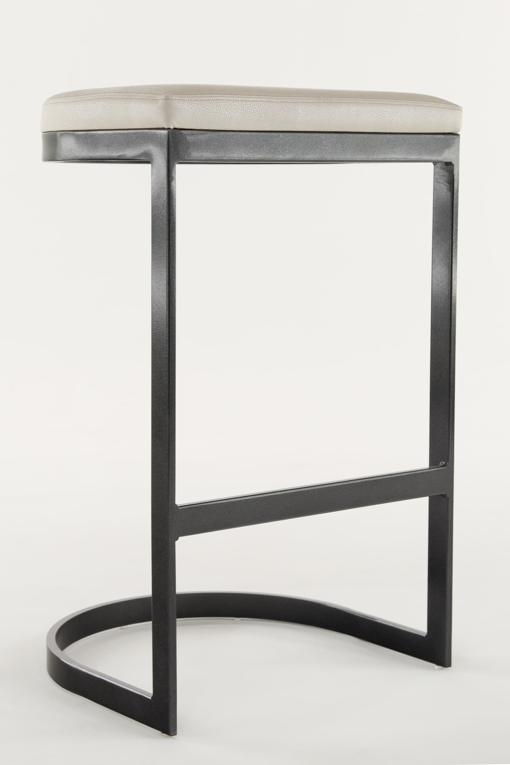 A contemporary backless bar stool featuring a charcoal gray powder-coated metal frame with a sled base and an integrated footrest, topped with a padded rectangular seat upholstered in light gray faux leather. — 3D model