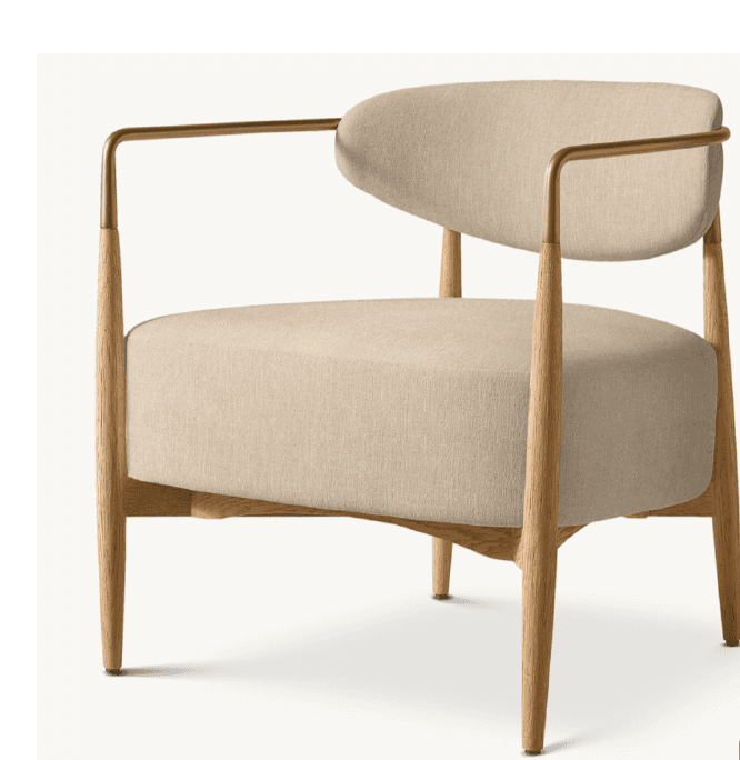 A modern armchair featuring a light-colored fabric upholstery, a wooden frame, and brass armrests. The chair has a rounded backrest and a comfortable seat cushion, supported by four tapered wooden legs. — 3D model