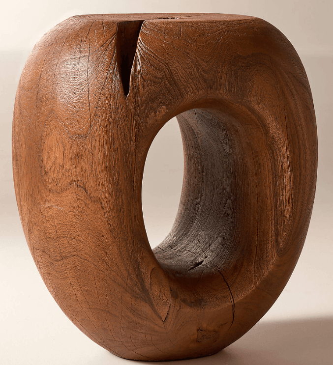 A solid wood stool with a toroidal or donut-like shape. It features a large central void and a carved, organic form. The surface shows wood grain and some natural imperfections. — 3D model