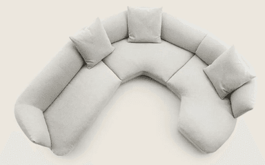 A sectional sofa with a curved, semi-circular configuration. It features multiple seating sections and includes four throw pillows. The overall design is modern and minimalist, with soft, rounded edges and a plush upholstery. — 3D model