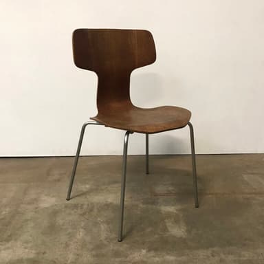 A modern, armless chair featuring a dark brown molded plywood seat and backrest, supported by four slender silver-colored metal legs. — 3D model