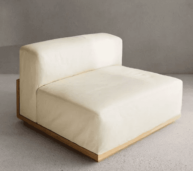 An armless modular seating unit upholstered in a light cream or off-white fabric, designed to integrate into a larger sectional sofa. It features a clean, contemporary design with plush, rectilinear cushions and a visible, recessed light-toned wood base. — 3D model