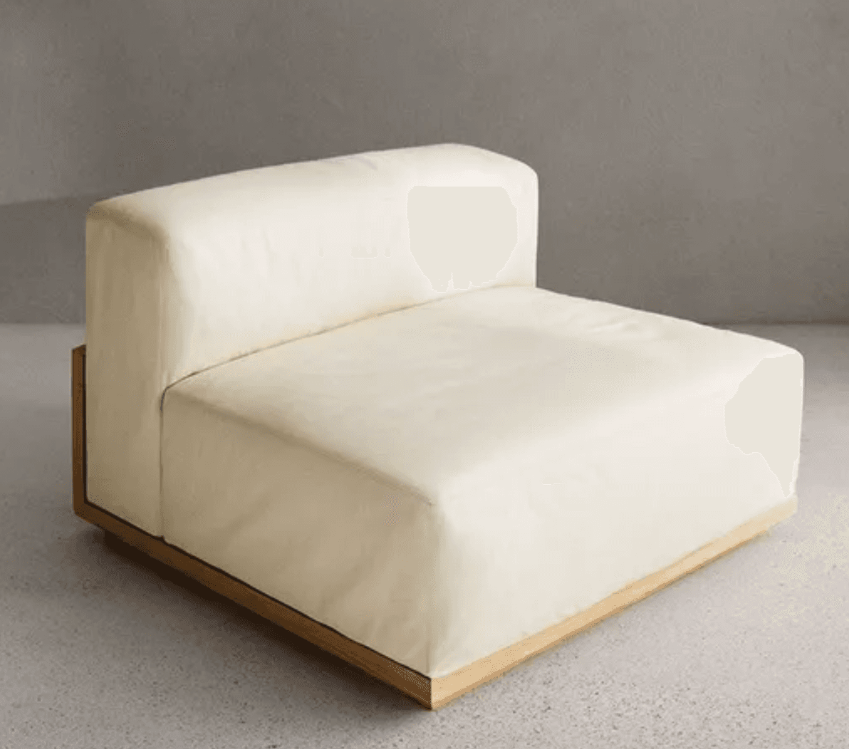 An armless modular seating unit upholstered in a light cream or off-white fabric, designed to integrate into a larger sectional sofa. It features a clean, contemporary design with plush, rectilinear cushions and a visible, recessed light-toned wood base. — 3D model