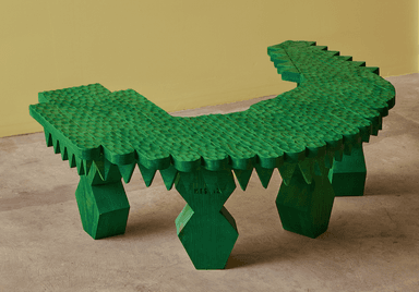 A vibrant green, elaborately carved low bench, shaped with an undulating profile reminiscent of a crocodile or dragon. The top surface is textured with a scale-like pattern, and the edges feature sharp, jagged protrusions. The bench is supported by chunky, faceted legs, all finished in the same bright green color. — 3D model