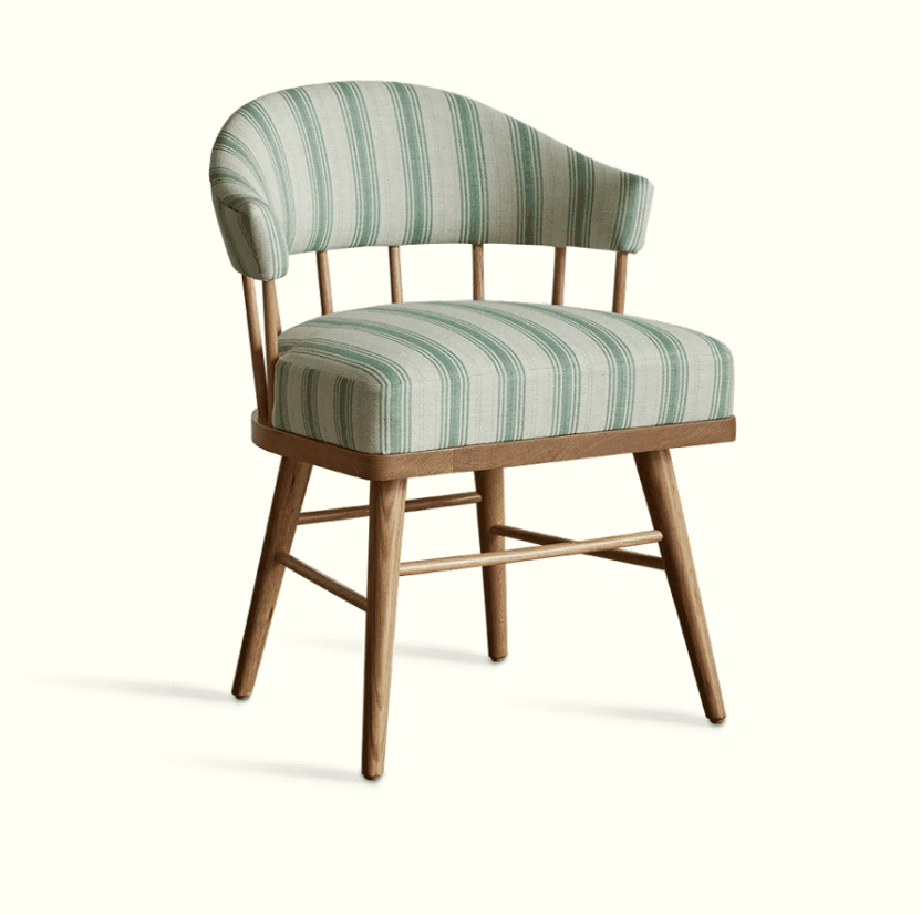 An accent chair with a wooden frame and upholstered seat and back. The chair features a curved backrest supported by vertical spindles and armrests that flow into the back. The seat and back are upholstered in fabric with a vertical stripe pattern. — 3D model