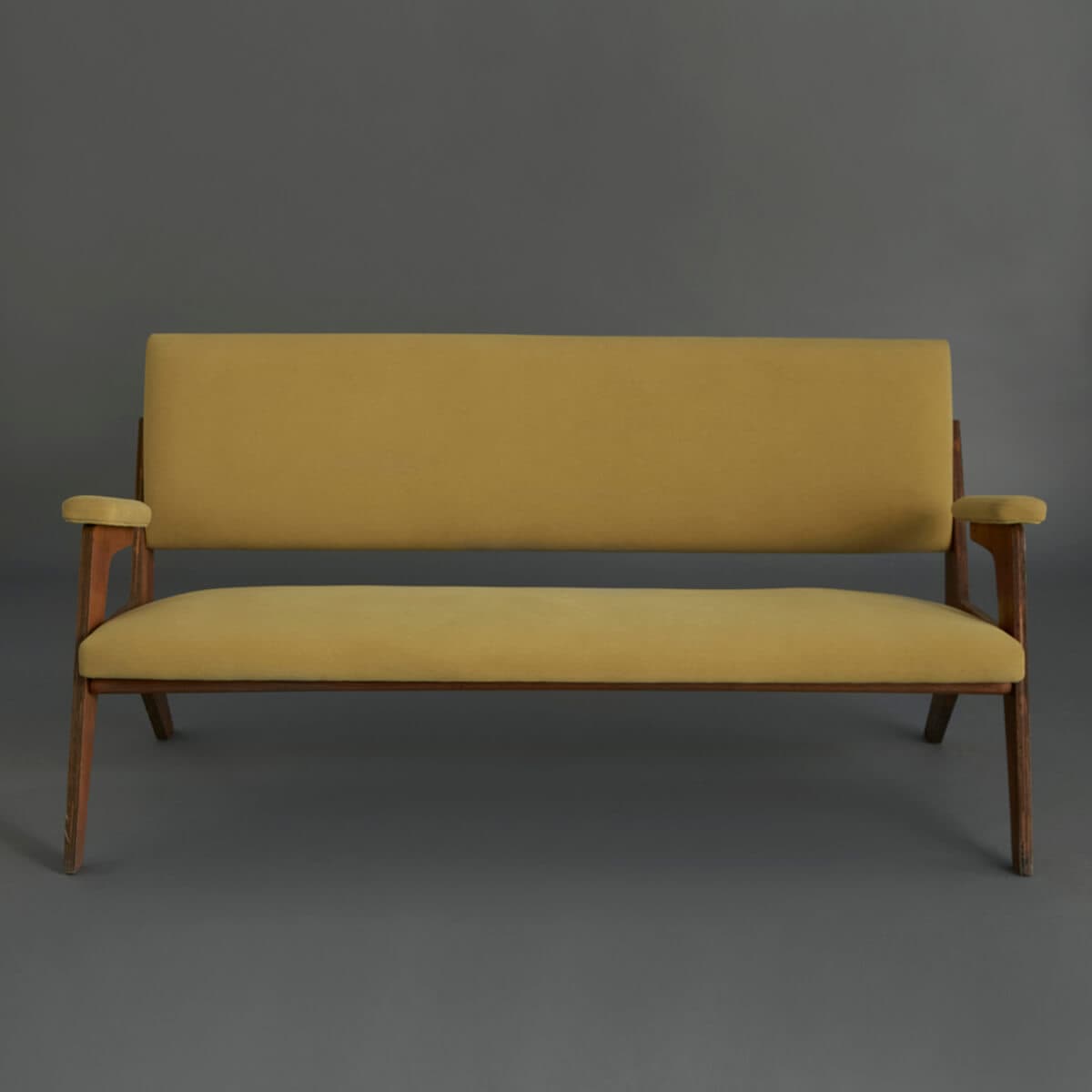A two-seater sofa with a wooden frame and upholstered cushions. The sofa features a rectangular backrest and seat, with slightly angled arms. The wooden legs are slender and tapered. — 3D model