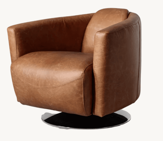 A contemporary swivel lounge chair upholstered in tan leather, featuring a rounded, integrated design with padded arms and a low-profile circular metal base. — 3D model