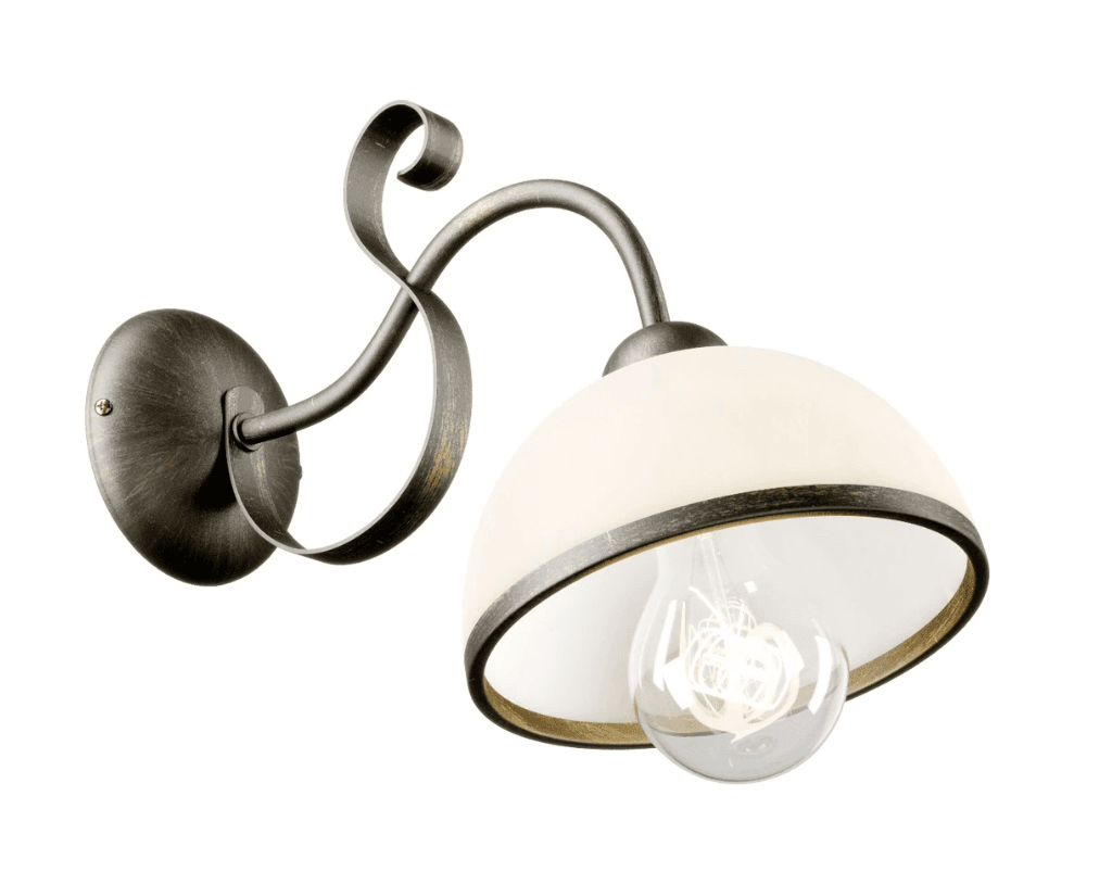 A traditional style wall sconce featuring an aged bronze finish on its metal frame and a frosted glass bell-shaped shade. The metal arm displays decorative scrollwork details, connecting the oval wall mount to the light fixture. A clear incandescent bulb is visible within the shade, which is held in place by a darker metal rim. — 3D model